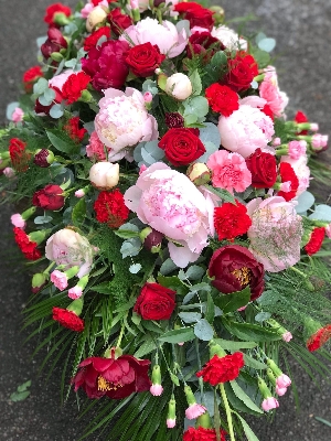 Pink and red casket spray