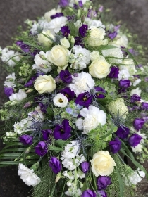 Purple and white casket spray