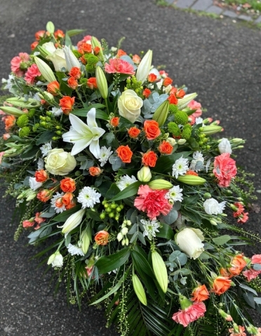 Green white and gold casket spray