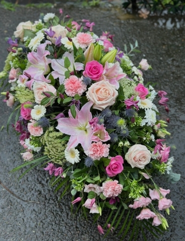 Pink garden style casket spray